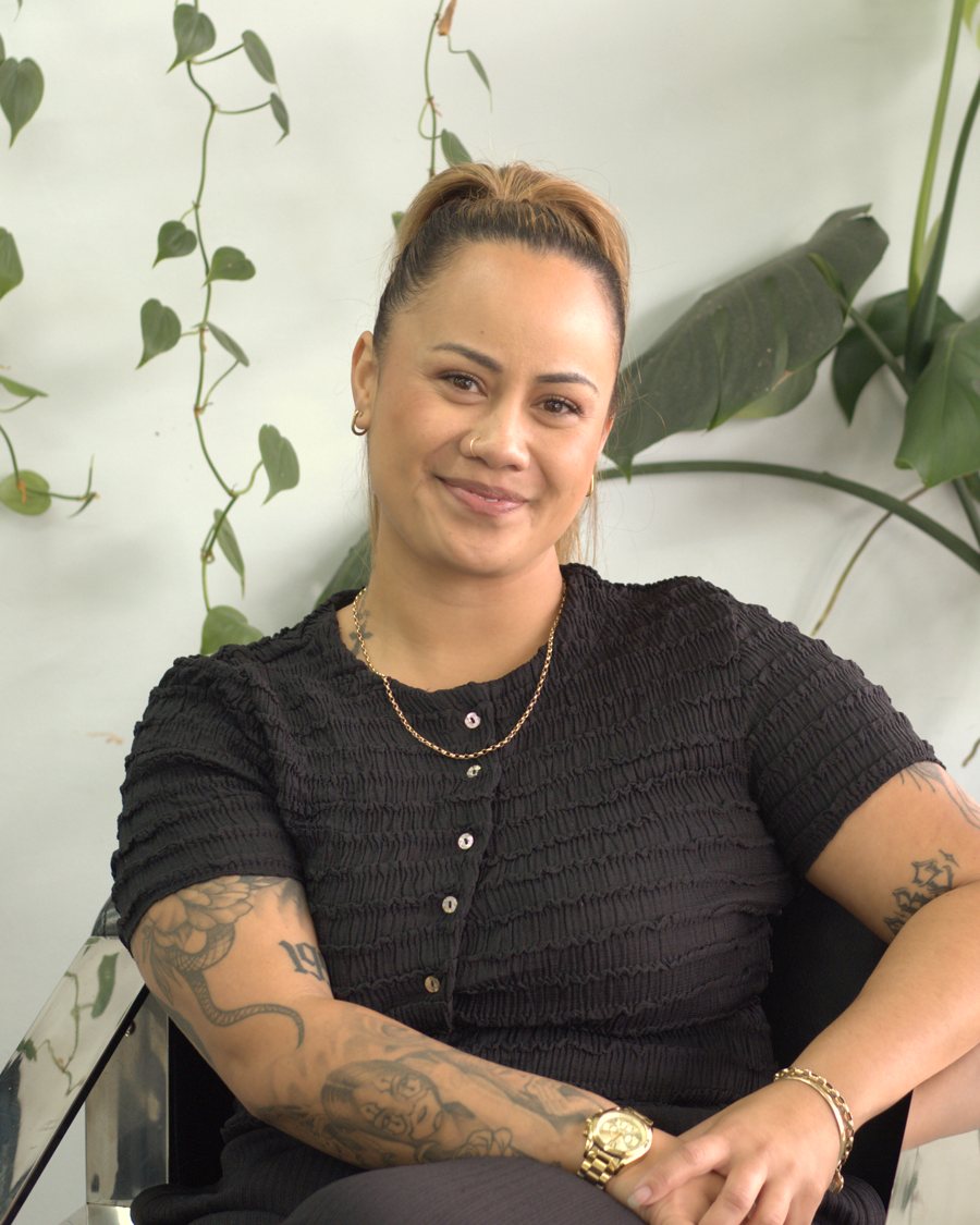 Liana, salon owner and advanced stylist, seated in the salon