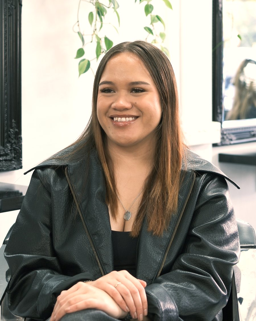 Shayla, senior stylist, seated in the salon
